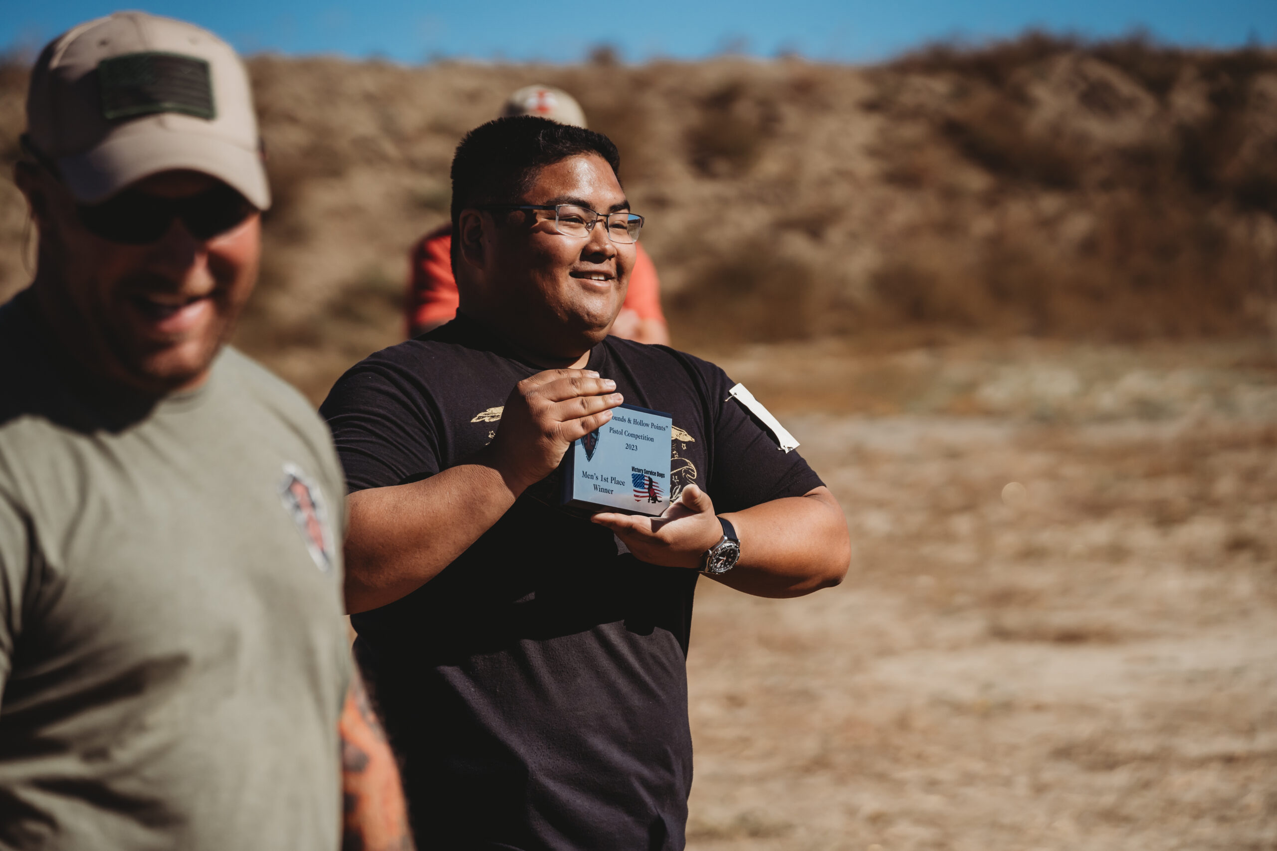 COMMUNITY PARTNERS 2 people standing on a shooting course