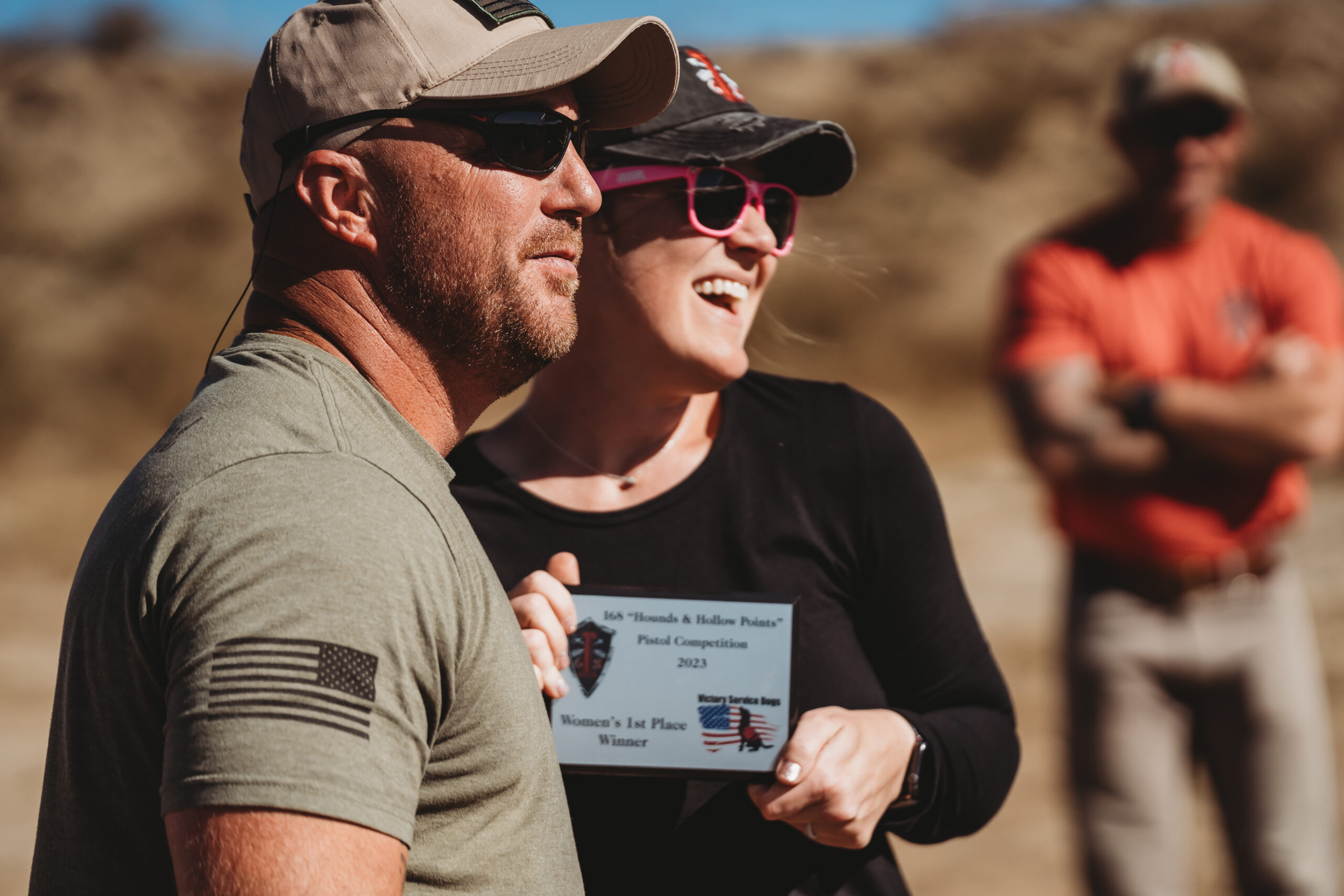 COMMUNITY PARTNERS 3 people standing on a shooting course